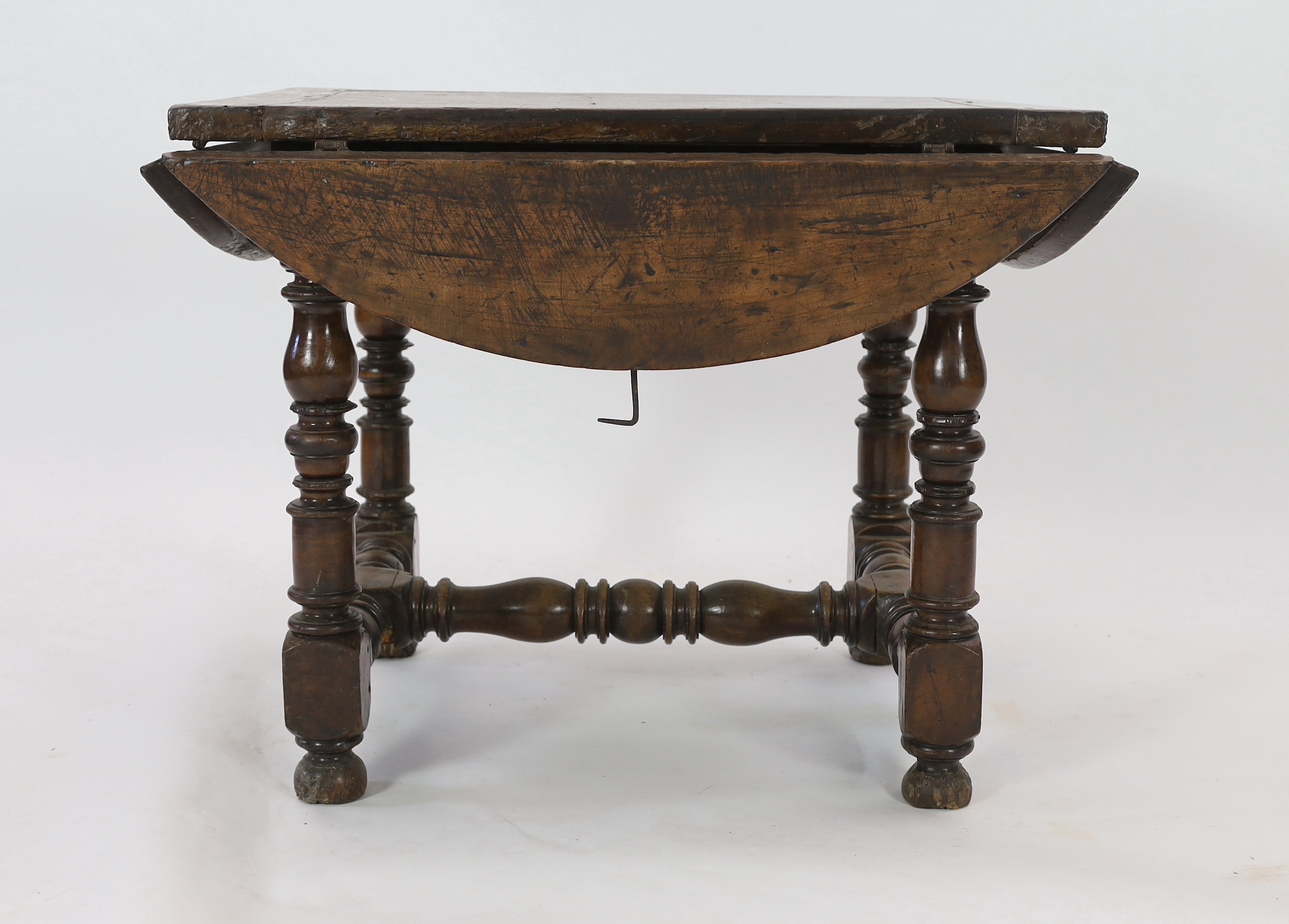 A late 17th century Spanish walnut dining table, 100 x 83cm with flaps down
